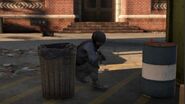 A NOOSE officer taking cover behind a trash can.