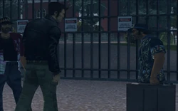 After the frisk, one of the Cartel gangsters opens the gate and signals for Claude to follow him inside.