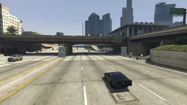 Spectators can be seen on the side of the highway and on the bridges.