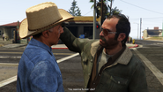 Trevor threatening Manuel at gunpoint.