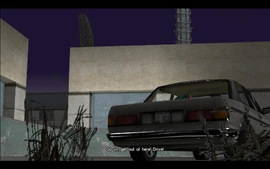 Tommy jumps into Ken's car through an open window and yells at him to drive him out of the docks.