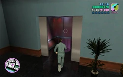 Tommy and the manager getting into the elevator.