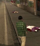 Grove Street member standing near some dead Ballas.