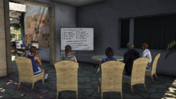 A view of the center's whiteboard, with a group therapy session at the table