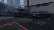 Two IAA agents in Unmarked Cruisers ambushing a player making a nightclub delivery in GTA Online.