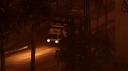 The front of an Isuzu Elf-inspired truck with box truck configuration in a postcard of 