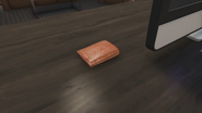 Wallet of the limo driver on the player's desk after completing Investigation: The Country Club (replaces the mansion photo).