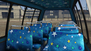 Tourbus-GTAVe-InteriorRear.png (3.14 MB) View of the interior seating area in the enhanced version of GTA V.