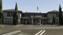 The front door of the country club and the parking lot.