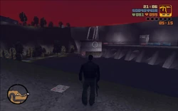 Catalina's white helicopter stationed on a small building at the end of the dam.