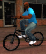 Victor Vance riding a BMX in GTA Vice City Stories.