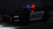 A Police Cruiser with lights and sirens activated. (Rear quarter view)