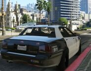 Rear view of a LSPD Police Cruiser with a glitched LED light bar during the mission "The Good Husband".