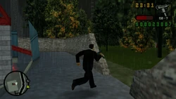 Escaping the warehouse and the Triads by using the wall destroyed by the explosion.