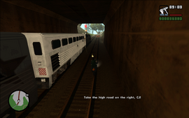 As the train, CJ and Smoke approach the end of the tunnel, it appears that the right side of the road is blocked. Smoke tells CJ to take the dirt track on their right.