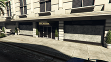 The boarded-up storefront of Luxury Autos as it looked at the debut of The Criminal Enterprises update.