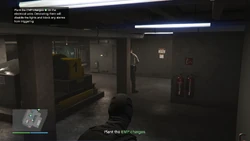 Plant the EMP charges on the electrical units. Detonating them will disable the lights and block any alarms from triggering