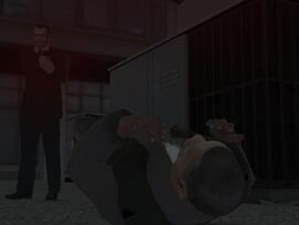 Niko standing over Clarence's dead body.