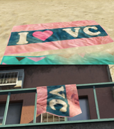 A beach towel on Vespucci Beach, and at The Pink Cage Motel, referencing Grand Theft Auto: Vice City.