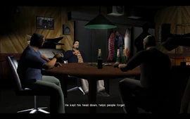 One of the men at the table say that Tommy was staying silent while incarcerated, which made people forget of his crimes.