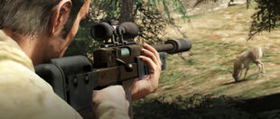 Trevor hunting with a hunting rifle.