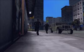 After a few moments pass, two robbers run out of the bank.