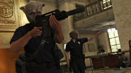 Official screenshot from the Heists update, displaying two GTA Online players wearing the Cop Outfit during a heist.