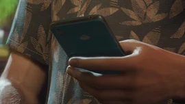 Jason Duval holding a blue iFruit phone in an official screenshot.