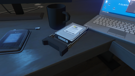 The stolen hard drive on Imani's desk in the player's Agency after completing the mission.