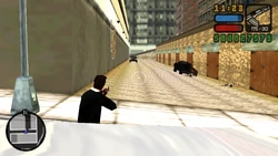 As Toni is about to enter the limousine, a pickup with a Forelli armed with an AK on the back comes from the alley.