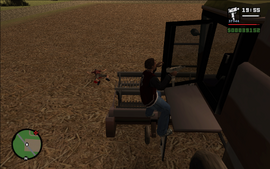 Carl climbing into the combine harvester.