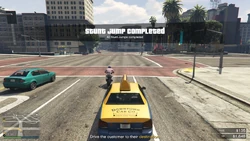 TaxiWork-GTAOe-StuntJumping.png (2.96 MB) Completing a Stunt Jump during the work.