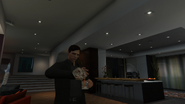 The GTA Online protagonist pouring a shot of The Mount whiskey.