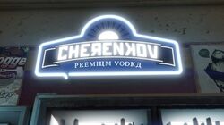 A neon Cherenkov Vodka sign in a store.