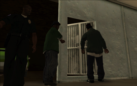 As Ryder and Smoke open the garage's gate, making room for the Sabre to drive out, Tenpenny walks out of the garage.