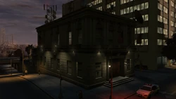 The Middle Park East Police Station at night, illuminated by floodlights