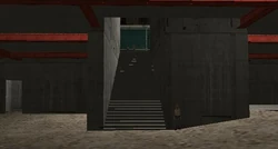 The building's main staircase being guarded by a construction worker.