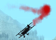 A Stuntplane with its red smoke ejector turned on.