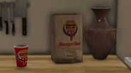 Cup and paper bag in the kitchen of Michael's mansion in Grand Theft Auto V.