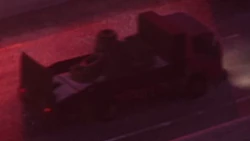 Rear side of an Isuzu Elf-inspired truck with flatbed configuration