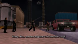 The dealer, Miguel, comes out of the Patriot telling Toni he's late.