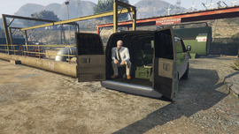 The Seller in the back of his Gun Van.