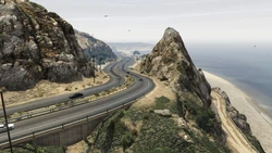 The large rock formation along Route 1 which is based on Point Mugu Rock in Malibu.