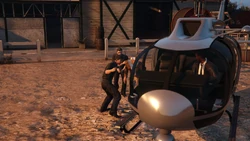 The guards usher Avery into the helicopter.