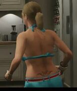 Tracy's tattoos seen on her back.