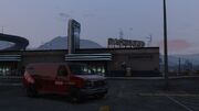 A Red Weazel News Rumpo in GTA V  (Rear quarter view).