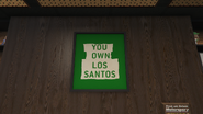 "You Own Los Santos" poster, appearing to be a modified version of the "Los Santos Owns You" poster found in Franklin's home.