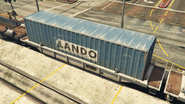 A short wellcar with a Lando container in transit.