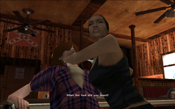 The woman manages to grab the man and holds him down, as she notices Carl's presence. She angrily asks him what he wants.