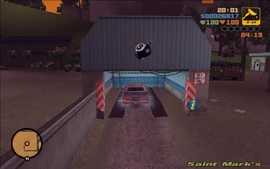 Claude getting the bomb put into the vehicle inside 8-Ball's garage.